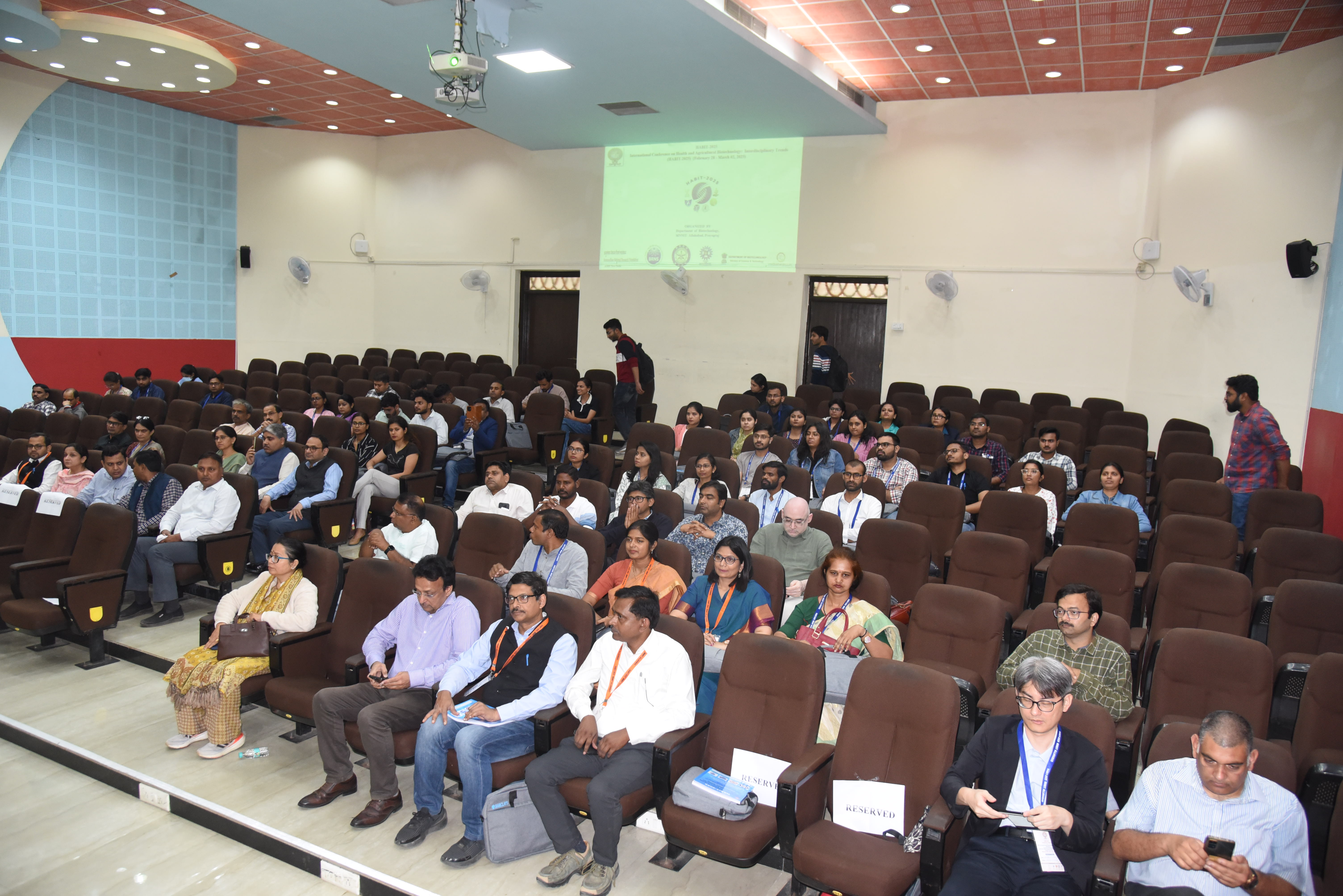 Delegates seated in the auditorium during a conference session