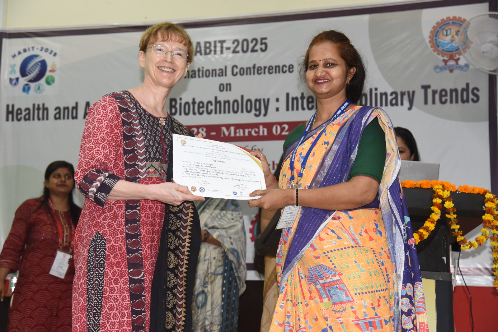 International delegate receiving a certificate at HABIT-2025