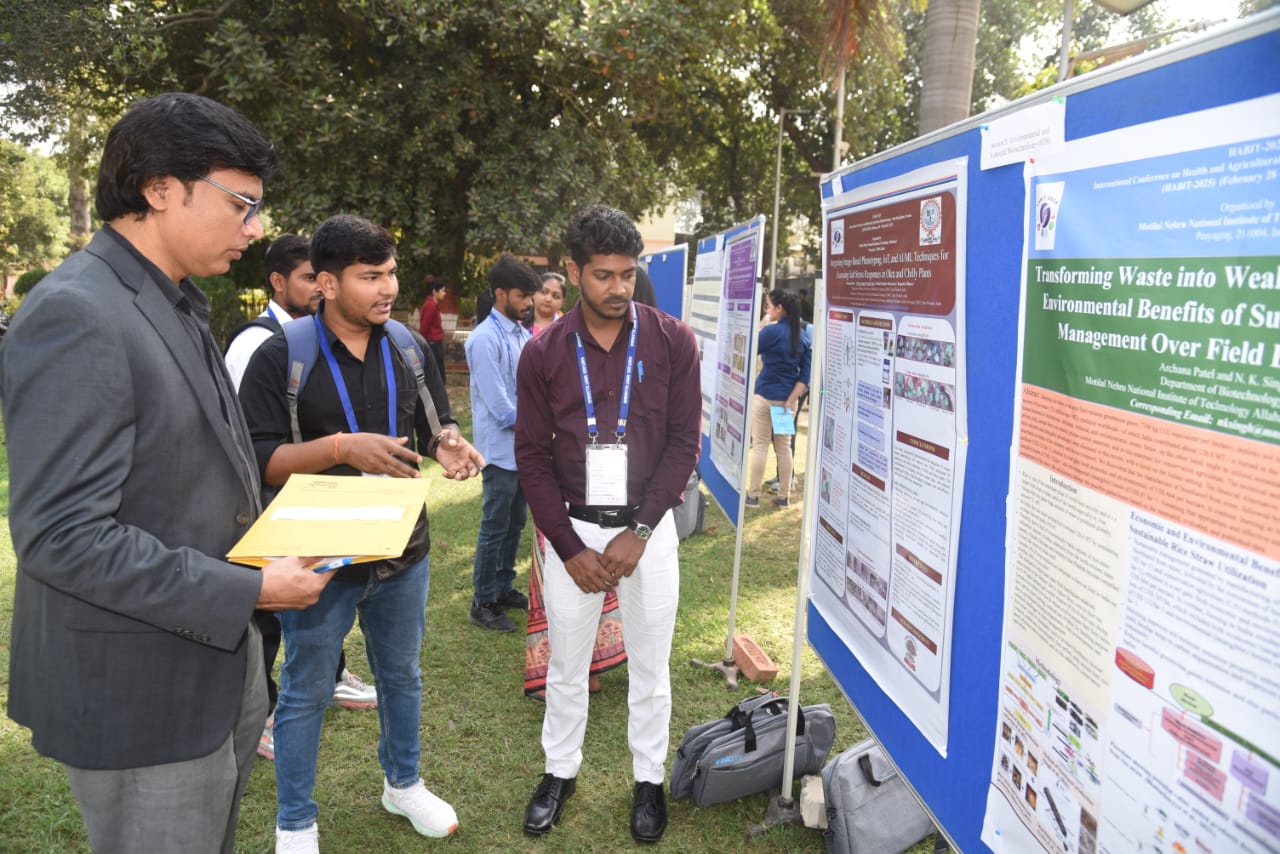 Students discussing a research poster during the poster session